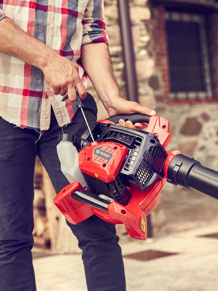 Cleaning outdoor areas with a Blue Bird petrol blower.