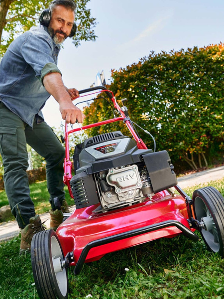 Lawn mowing with a Blue Bird lawnmower.