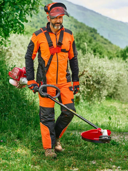 Mowing with a Blue Bird brushcutter.
