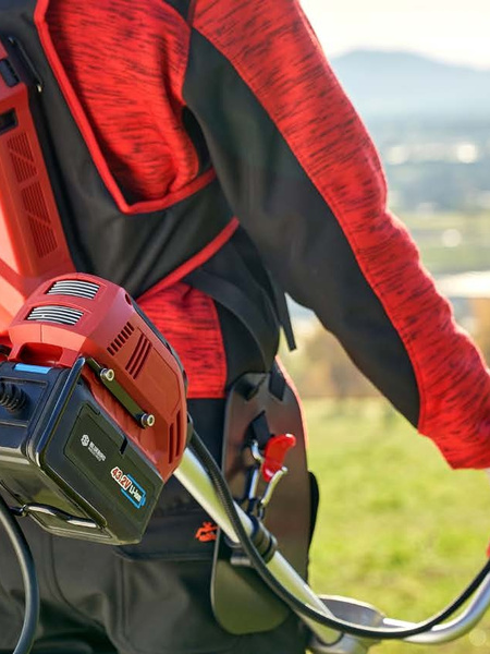 Mowing with a Blue Bird battery brushcutter.